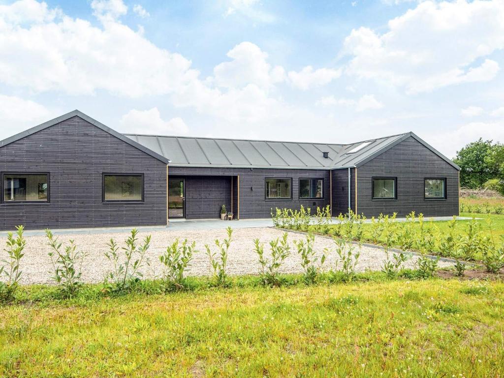 a gray house with a black roof at 5 star holiday home in Ansager in Ansager