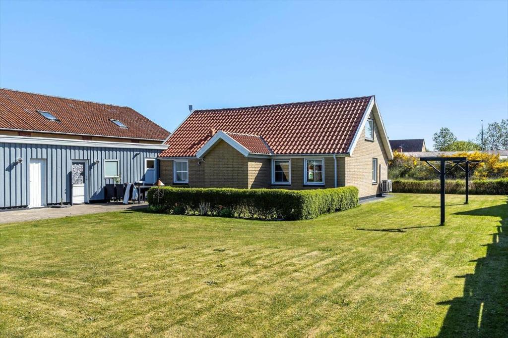 a house with a grass yard in front of it at TV1654-Albaek-Hovej-3 in Ålbæk