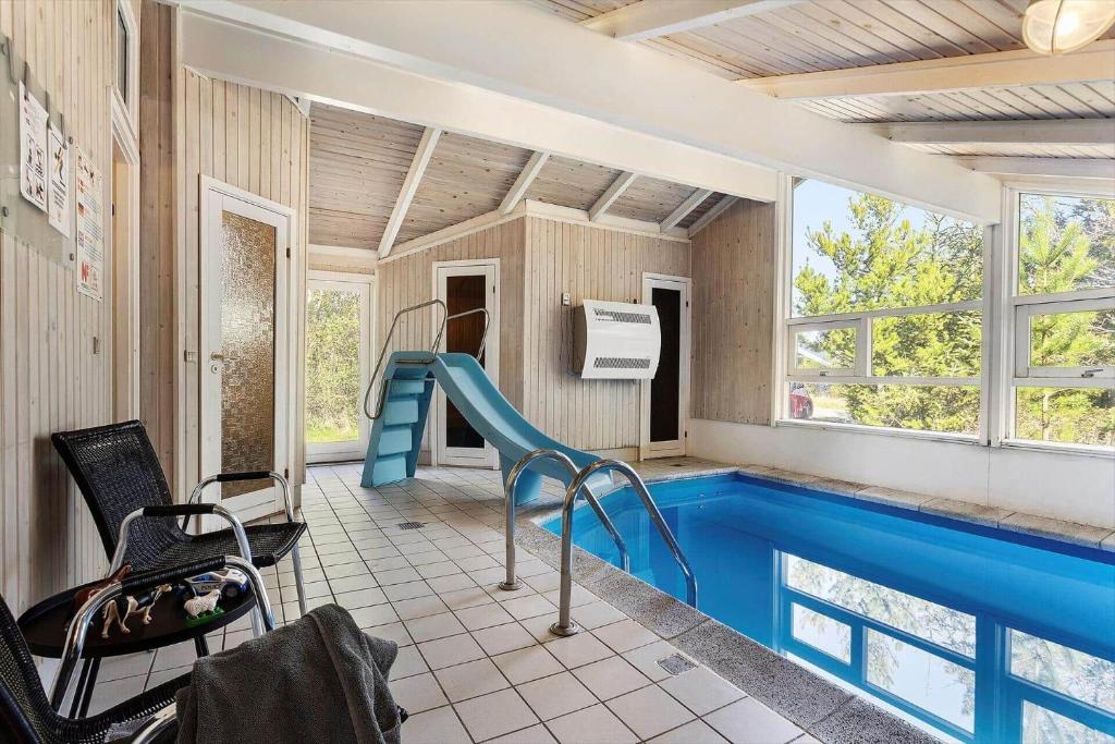 a house with a swimming pool with a slide at TV1660-Albaek-Lyngstien-6-A in Ålbæk