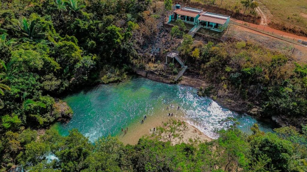 an aerial view of a river with a house on the shore at Casa Campo Serra Dourada in Manhã