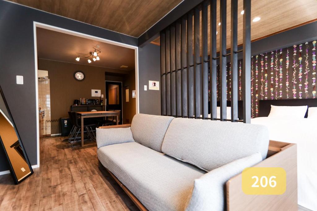 a living room with a couch and a table at Nishi-Funabashi Residence in Funabashi