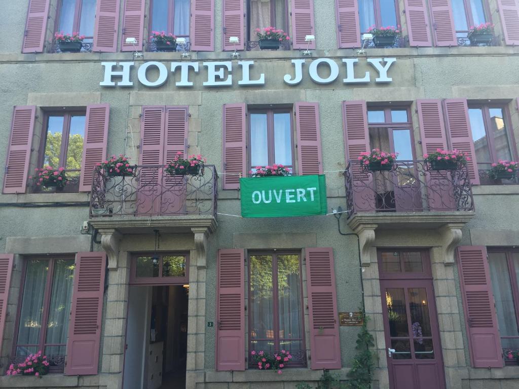 a hotel july sign on the side of a building at Location chambres Hôtel Joly in Dun-le-Palestel