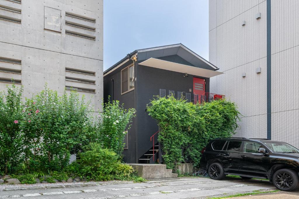 a black car parked in front of a building at SHINJUKU Garden-house in Tokyo