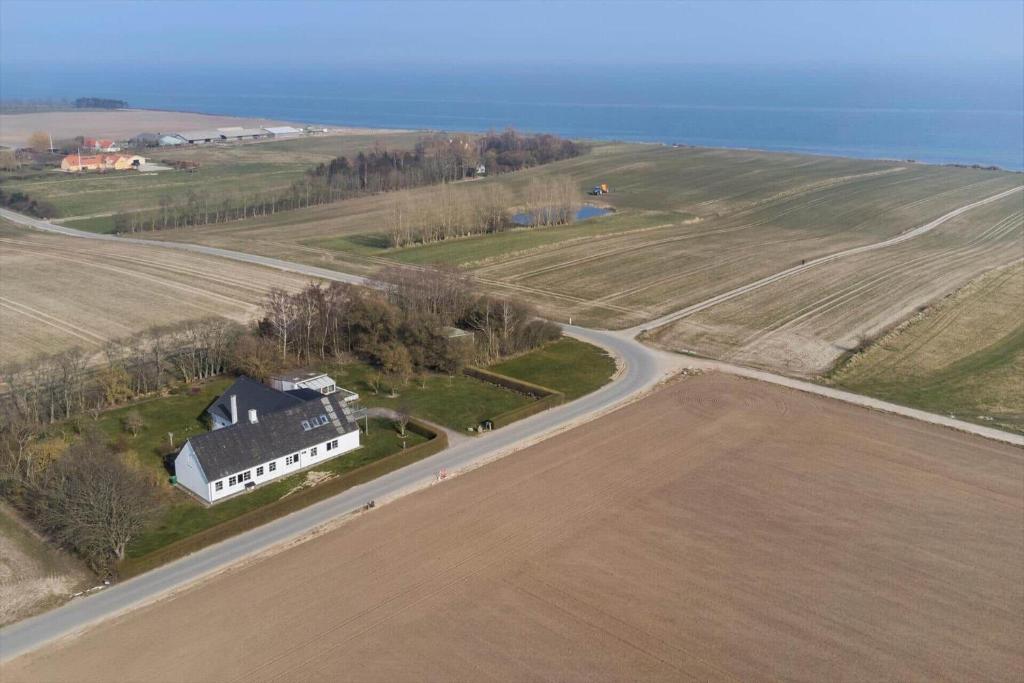 an aerial view of a farm with a house and a road at 20616-Samso-Norreskiftevej-40 in Brundbymark