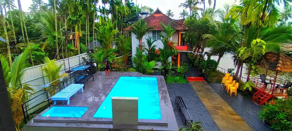 an overhead view of a swimming pool in front of a house at The Lake Paradise Boutique Resort in Alleppey