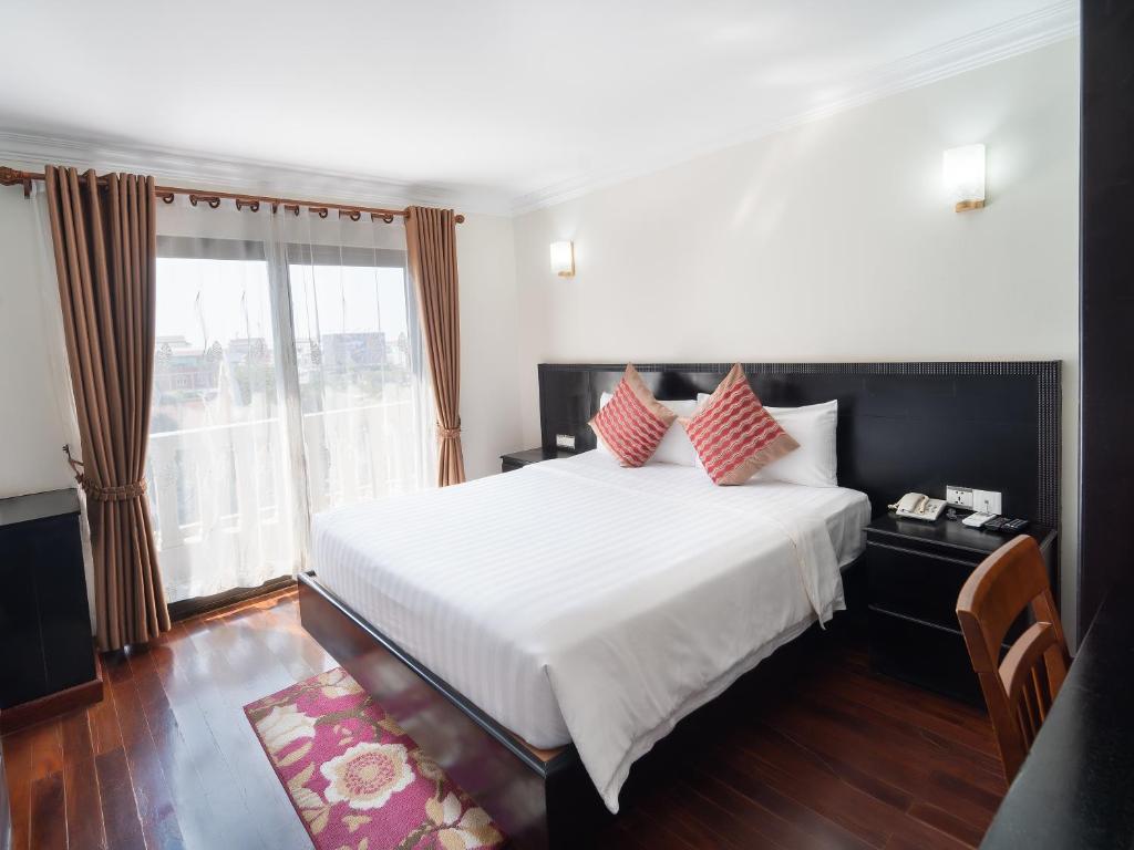 Ένα ή περισσότερα κρεβάτια σε δωμάτιο στο Haiven Hotel & Restaurant