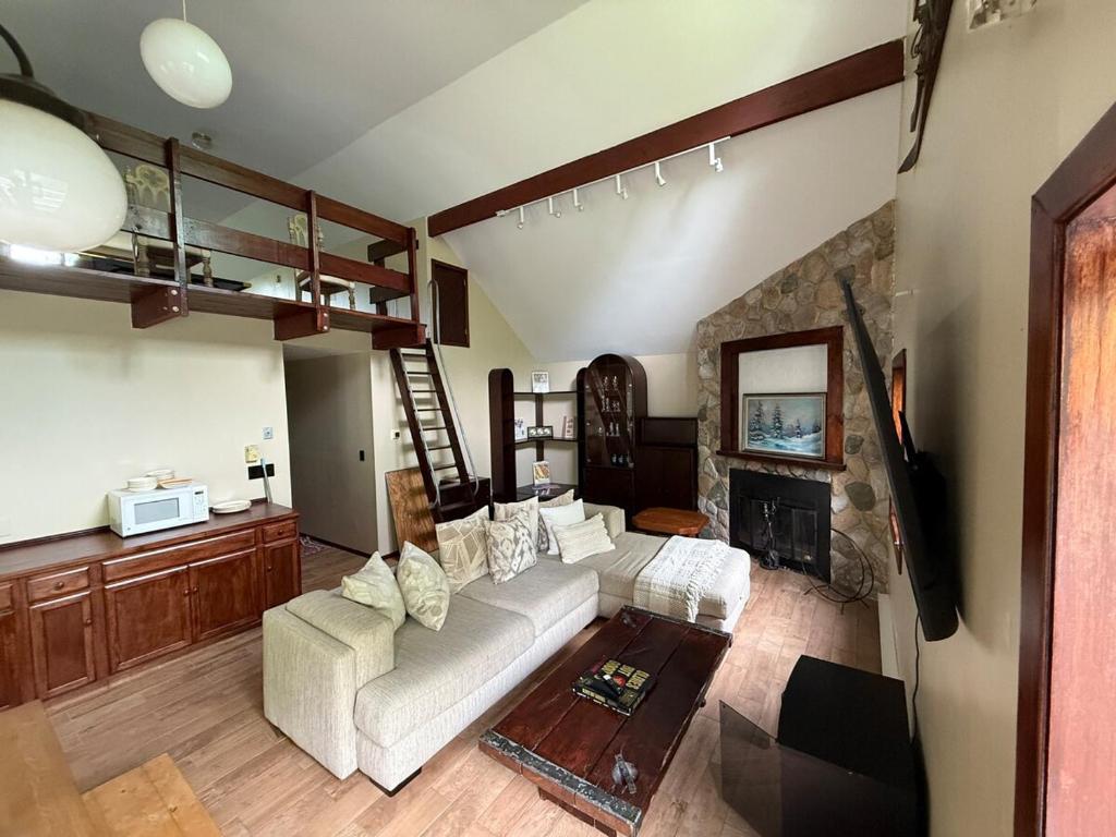 a living room with a couch and a fireplace at Luxury Mountain Getaway - 6 bed, 3 bath, hot-tub, fire-pit, game-room in Hunter