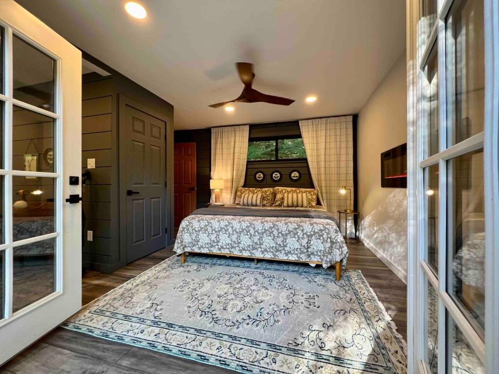 a bedroom with a bed and a ceiling fan at Gwen's Cottage at Water's Edge in Portersville
