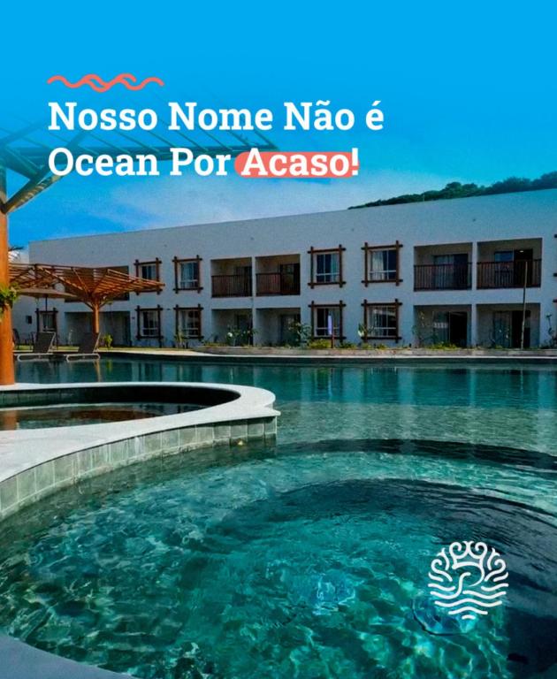 a swimming pool in front of a hotel at Pipa Privilege Ocean in Pipa
