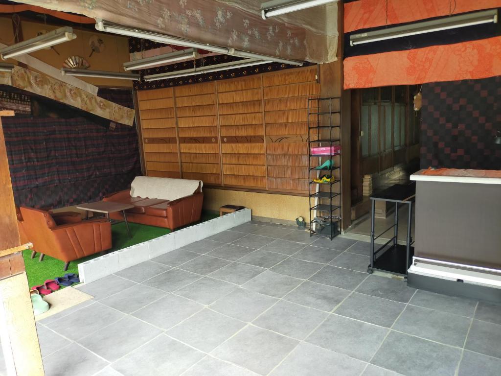 a room with a table and a bench in a building at 民泊いなほ館 in Shiso