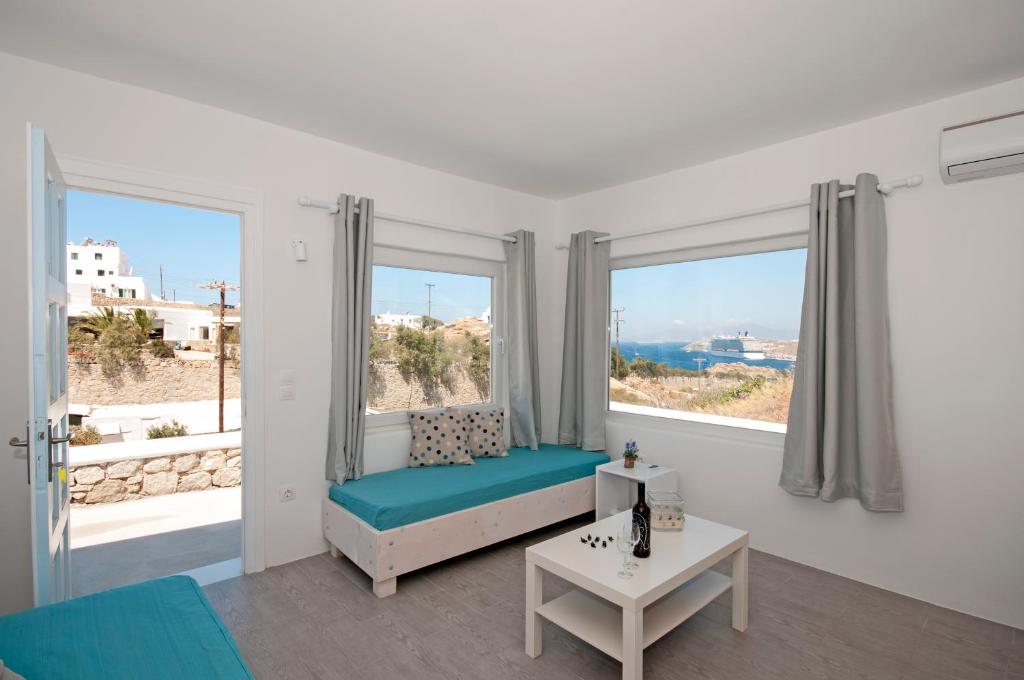 a white room with a bed and a large window at Marina's House in Tourlos