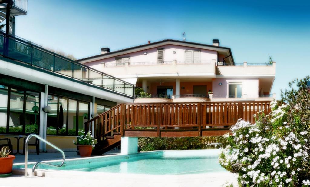 a house with a deck and a swimming pool at Villa Dei Romanzi in Tortoreto Lido