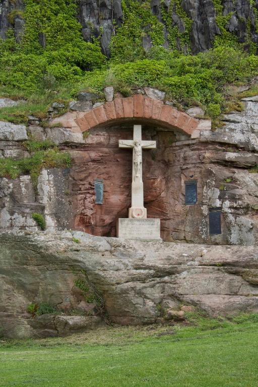 a cross on the side of a stone wall at Pintail Apartment Bamburgh in Bamburgh