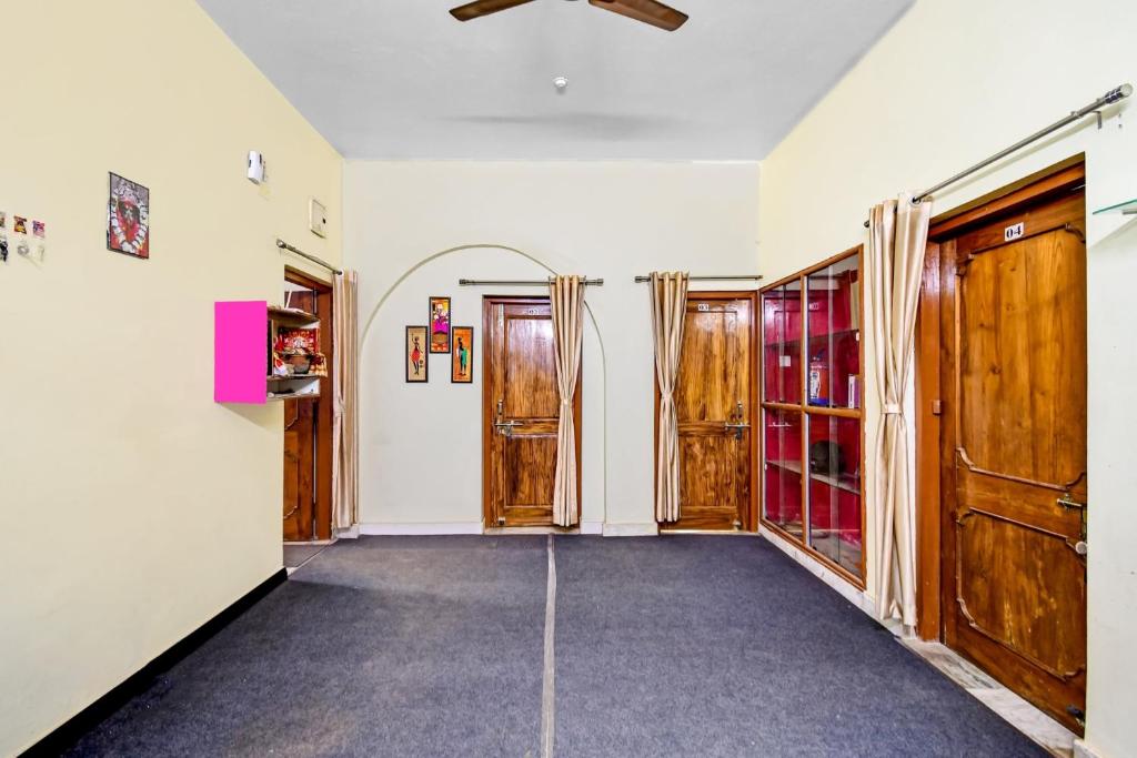 a hallway with wooden doors and a ceiling at Hotel O A1 Residency in Bhubaneshwar