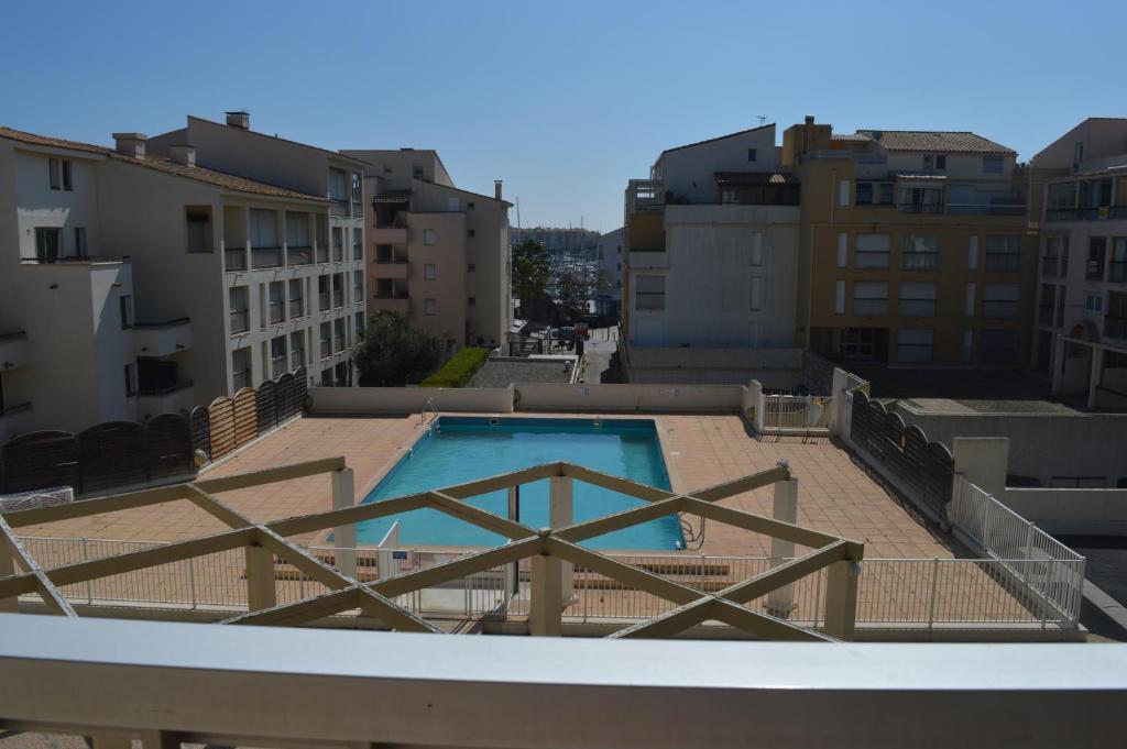 a swimming pool on the roof of a building at Résidence Orion Les Jardins de la Madragde in Cap d'Agde