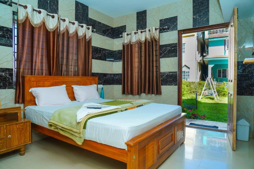 a bedroom with a bed and a large window at Jevis daffodils in Ooty