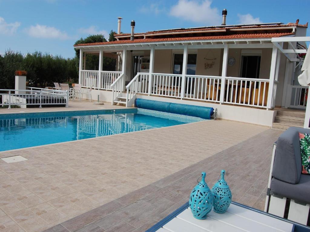 two blue vases sitting on a table next to a swimming pool at Villa in Sisi near Beach & Olive Groves in Milatos