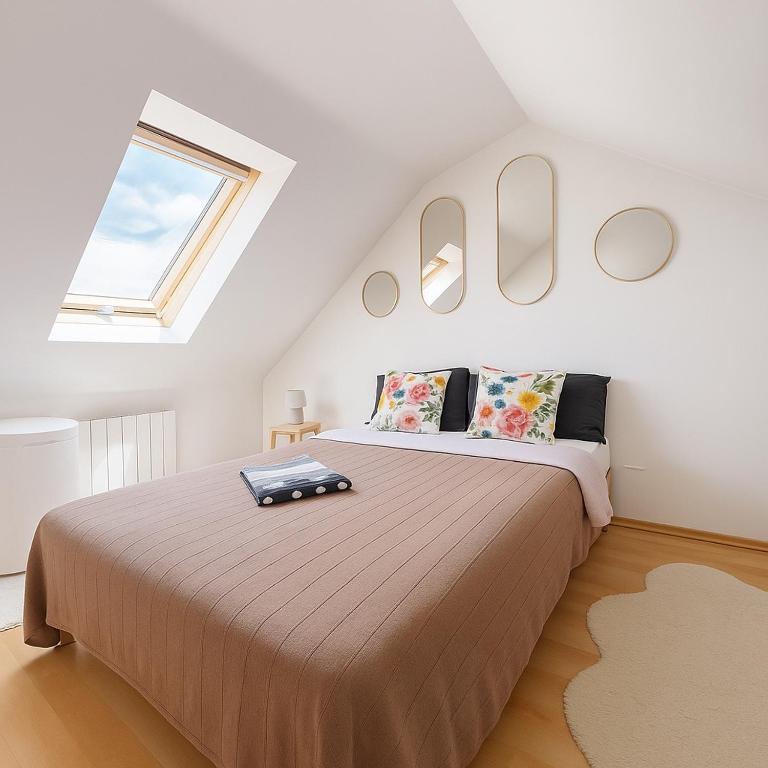 a bedroom with a large bed in a attic at Roissy CDG, private room 4 in Roissy-en-France
