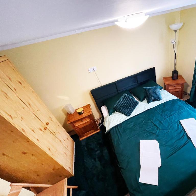 a bedroom with a bed with a blue comforter at Apartament Economy in Maków Podhalański