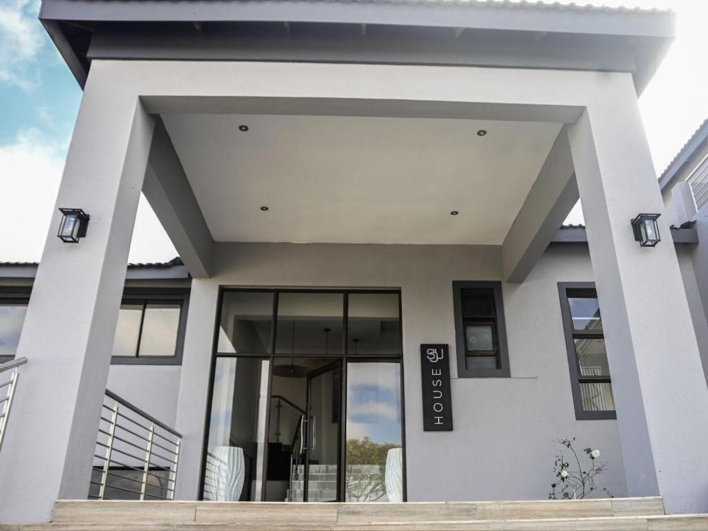 a white house with a large glass door at Sou House in Louis Trichardt