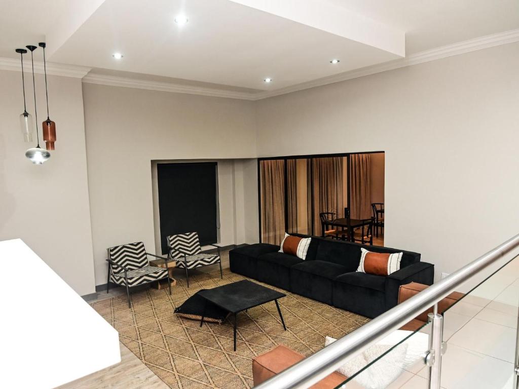 a living room with a couch and a table at Sou House in Louis Trichardt