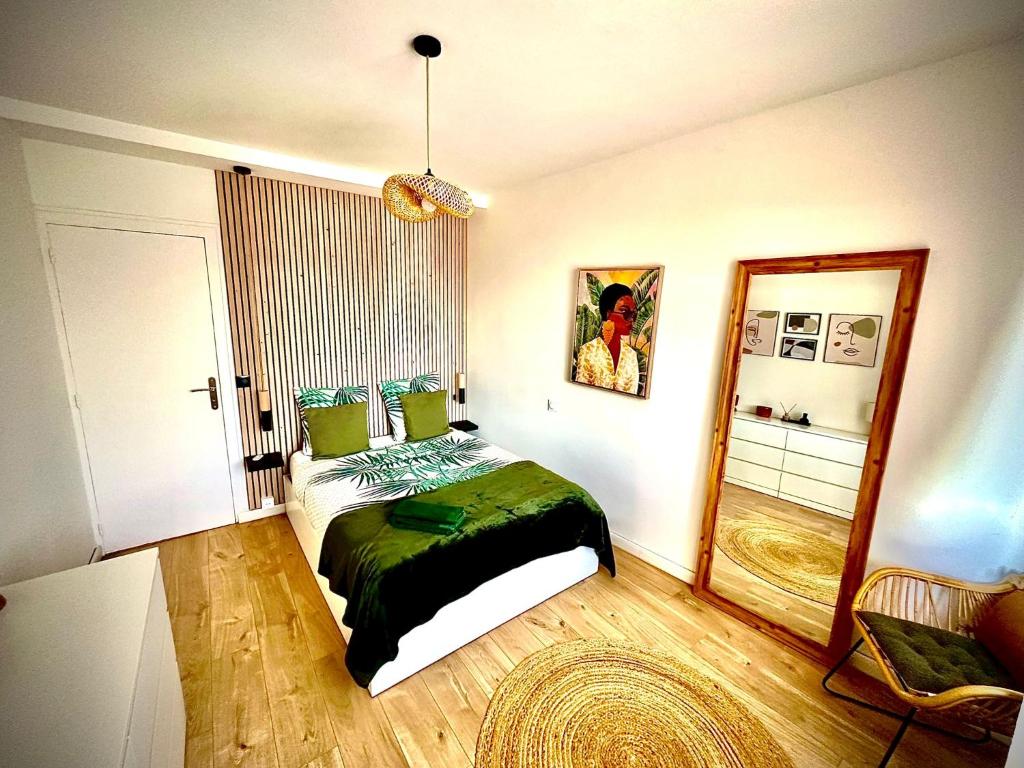 a bedroom with a bed and a mirror at Appartement au cœur de la cité d'Angoulême in Angoulême