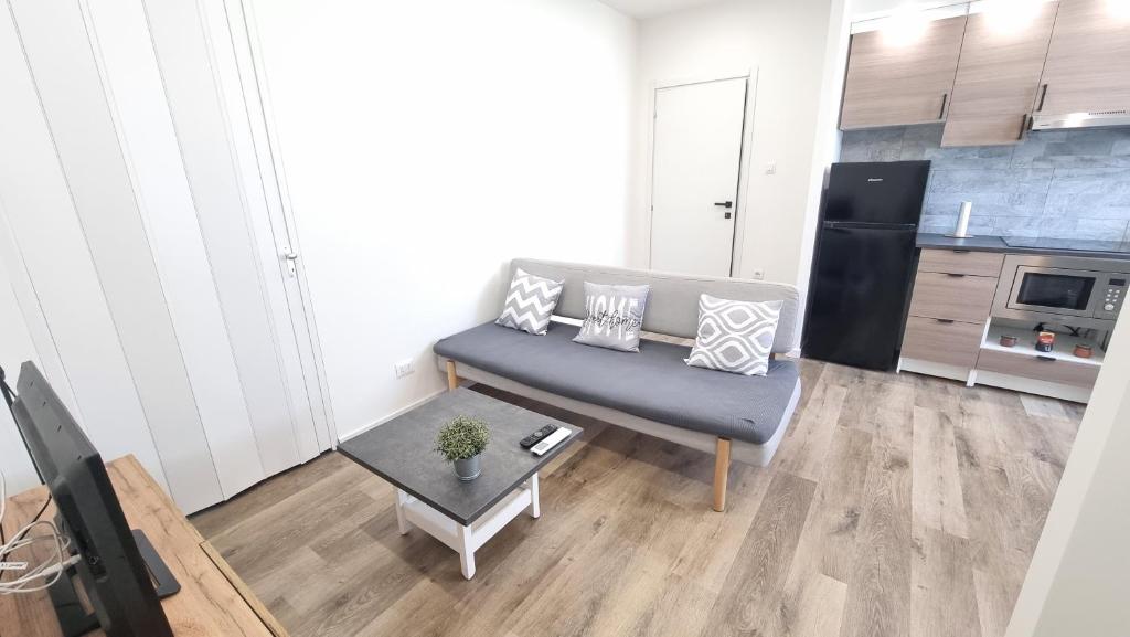 a living room with a couch and a table at Trieste Centro Secret Garden in Trieste