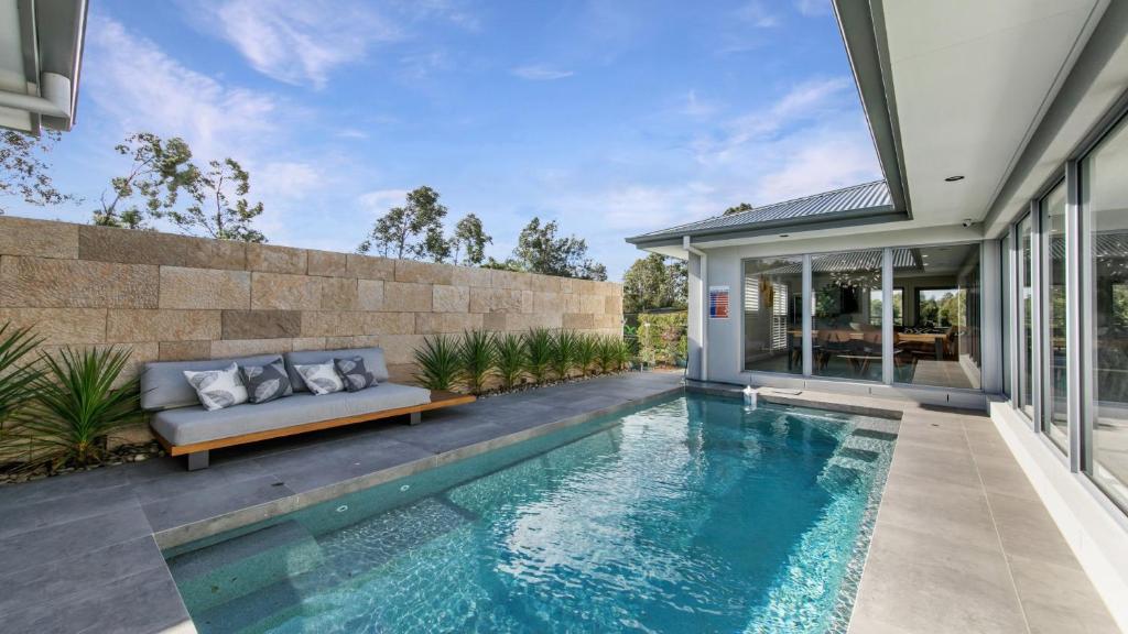 a swimming pool in the backyard of a house at Hunter Valley Wildflower in Pokolbin