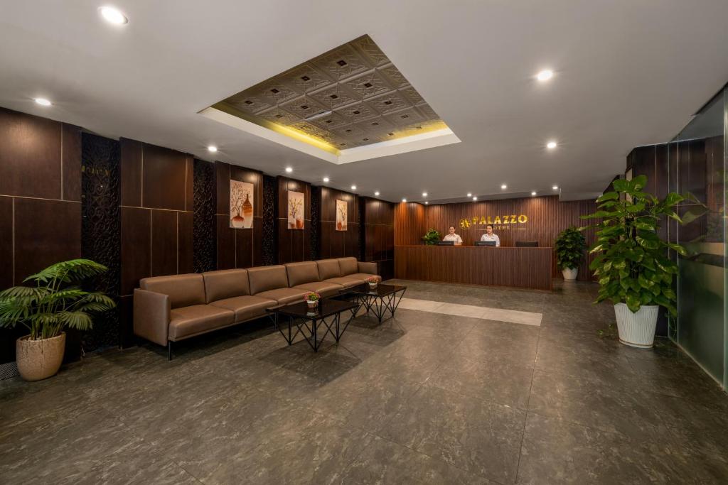 A spacious, dark-toned lobby with sofas facing the reception desk.