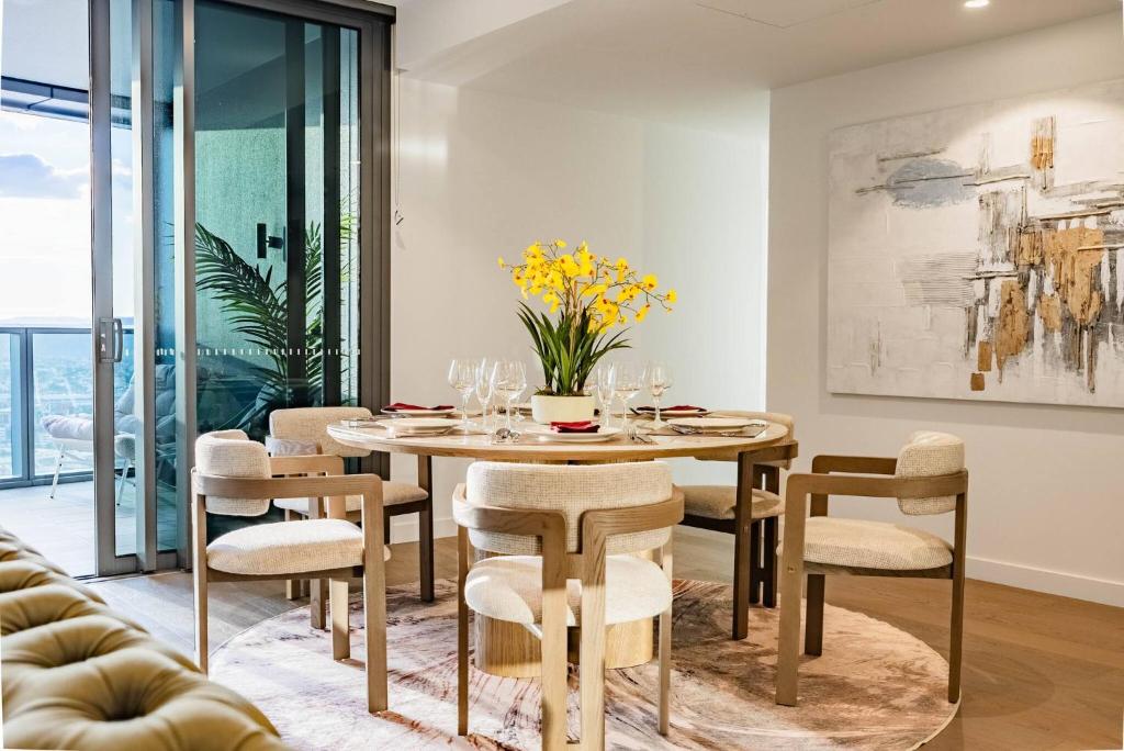 a dining room with a table and chairs at 3Bed Apt in Queen's Wharf - level 33 City and Riverview with Carpark in Brisbane