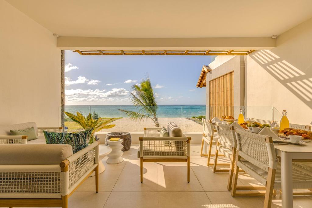 a living room with a view of the beach at Le Dalblair by Horizon Holidays in Pointe d'Esny