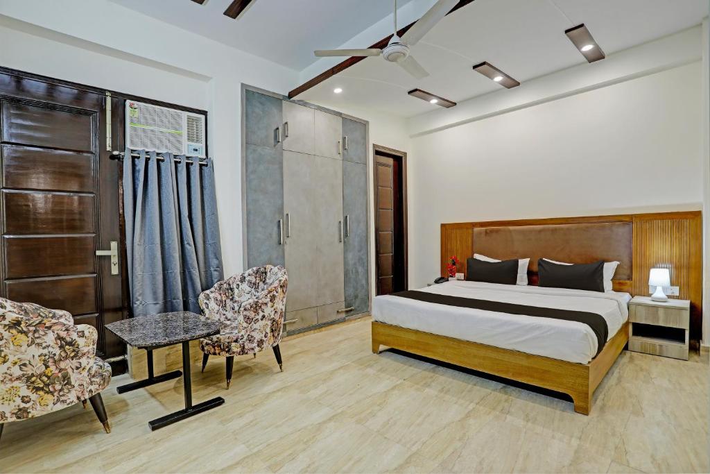 a bedroom with a bed and a table and chairs at Townhouse DSR SECTOR 19 in Noida