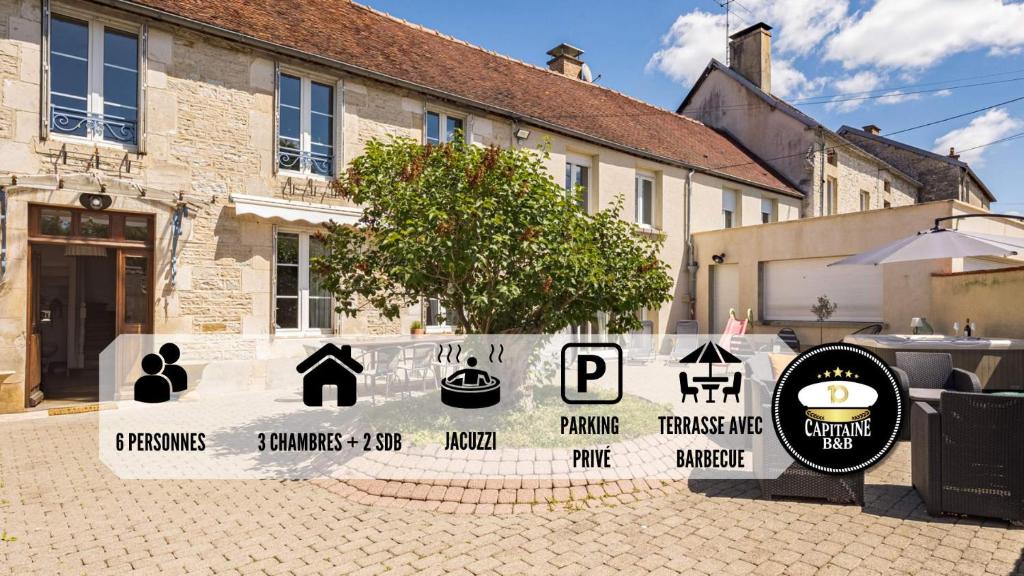 a sign in front of a building with signs on it at Villa des Lilas - Champagne & SPA - 6 pers in Buxeuil