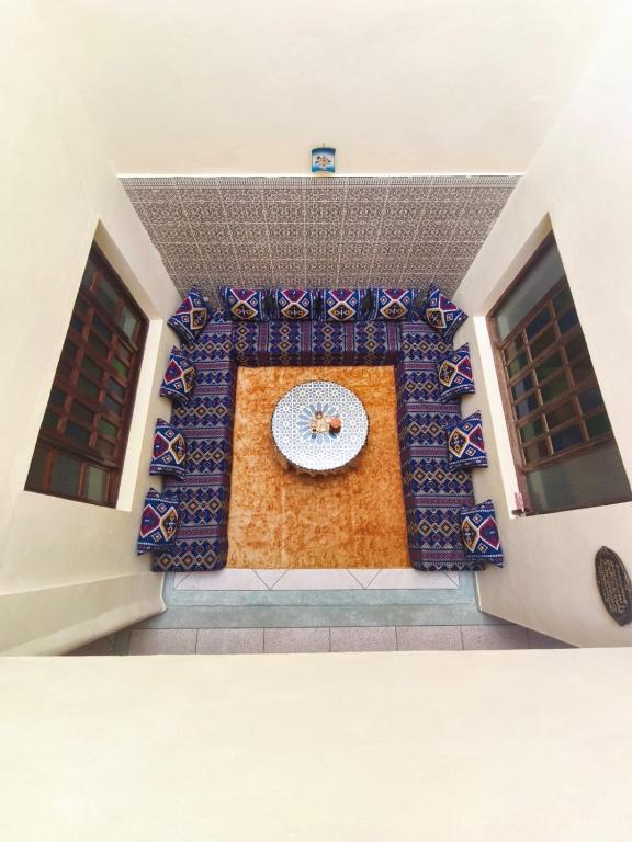 a room with a clock in the middle of a building at Maison LFarah Agadir in Agadir