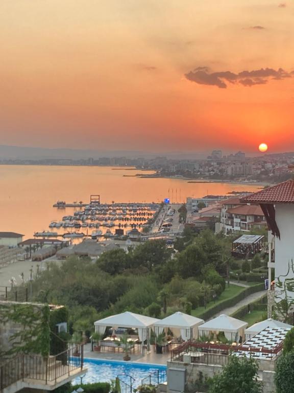 a view of the ocean from a resort at sunset at Dolce Vita Blue Boho, Premium Apartment with seaview in Sveti Vlas