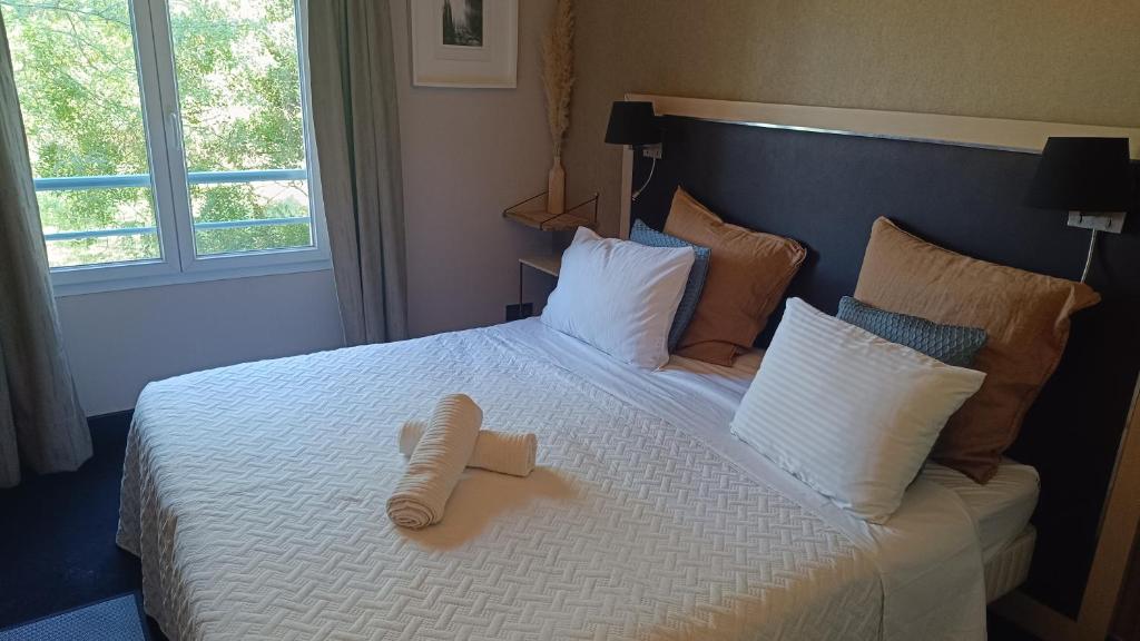 a hotel room with a bed with a book on it at GREEN Studio climatisé, vue sur golf proche Montpellier in Montpellier
