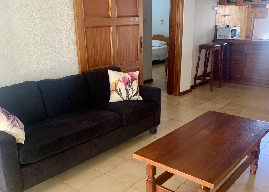 a living room with a couch and a coffee table at Sandy Beach Villas Sea View Apartment Pyla in Larnaka
