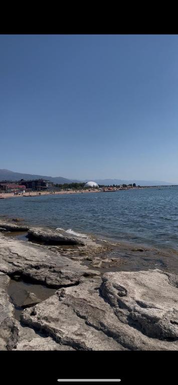 a view of the ocean with rocks and water at Кыргызское ВЗМОРЬЕ in Bosteri