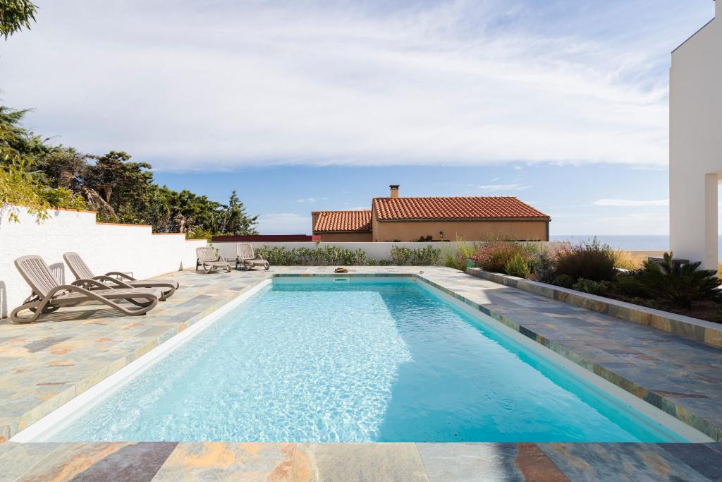 a swimming pool in the backyard of a house at Dream Vacation In A Beautiful Villa in Cerbère