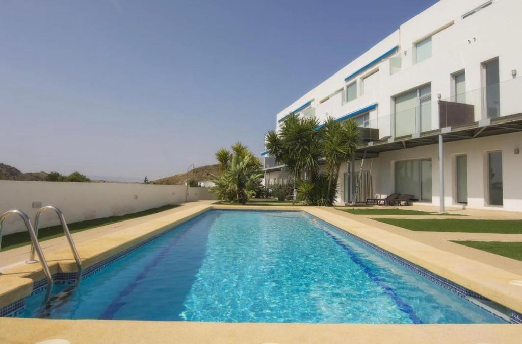 a swimming pool in front of a building at La Villa Dorada in Mojácar