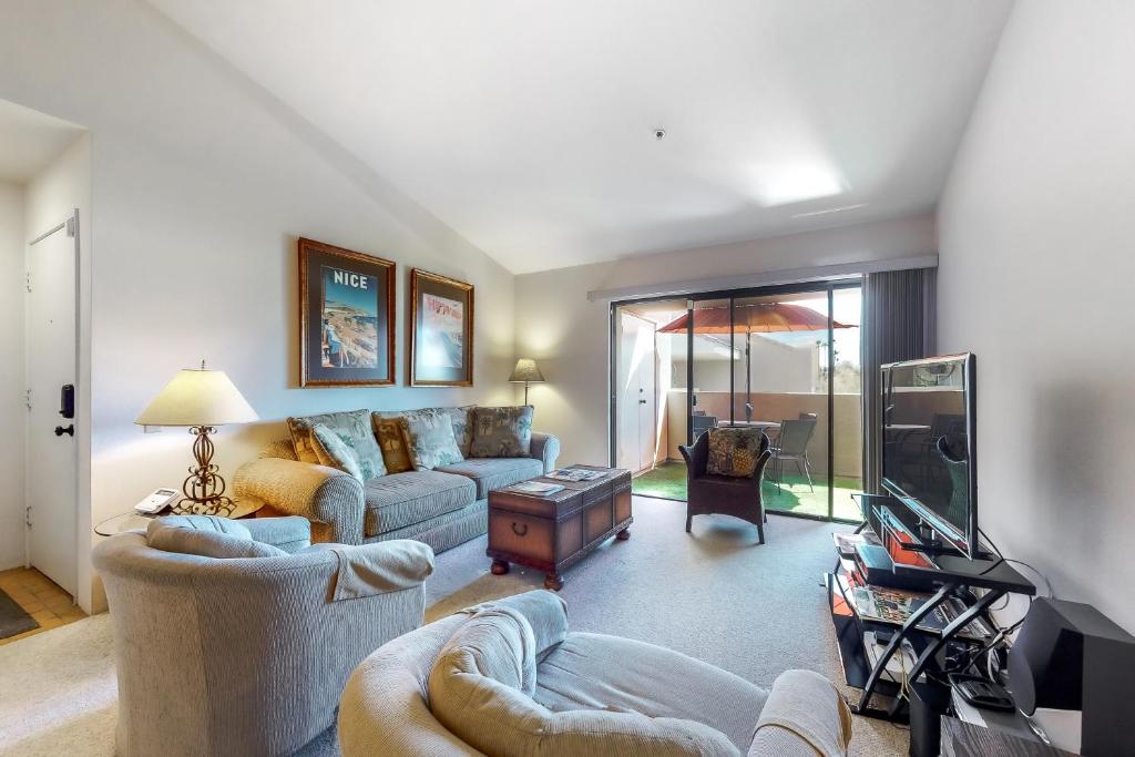 a living room with two couches and a tv at Plaza Villa Downtown Condo - 2877 in Palm Springs