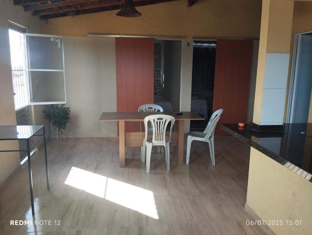 a dining room with a table and two chairs at Apartamento Avenida 31 in Barreirinhas