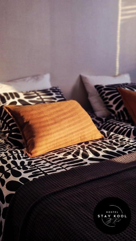 a black and white bed with a pillow on it at Stay Kool in Kiuruvesi