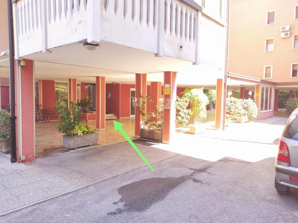 a building with a green arrow in front of it at RESIDENZA DE' MEDICI - Elegant Retreat in Vicenza