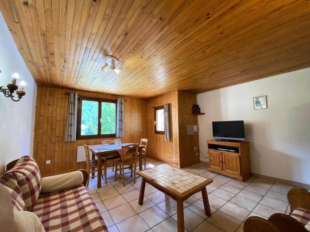 a living room with a wooden ceiling and a table at Résidence Andagne - Appartement spacieux bien situé MAE-2423 in Bessans