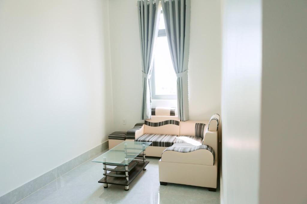 a living room with a couch and a table at Sunny Villa Hà Tiên in Ha Tien