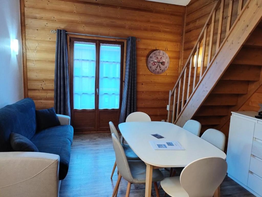 a living room with a table and chairs at Résidence Lanslevillard Quartier Eglise - Le Flocon des Bois MAE-2503 in Lanslevillard