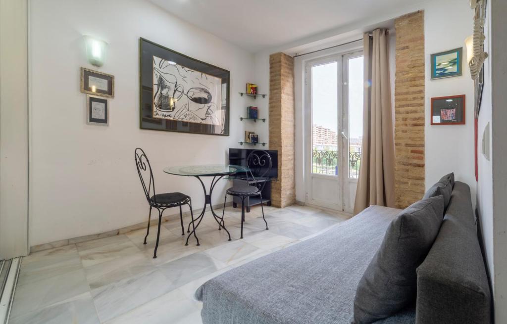 a bedroom with a bed and a table and chairs at Serrano Park in Valencia