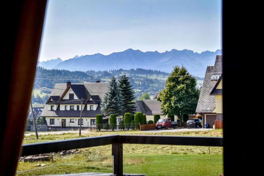 a view from a window of a town with mountains at Domek Jaroszówka z widokiem na góry in Zakopane