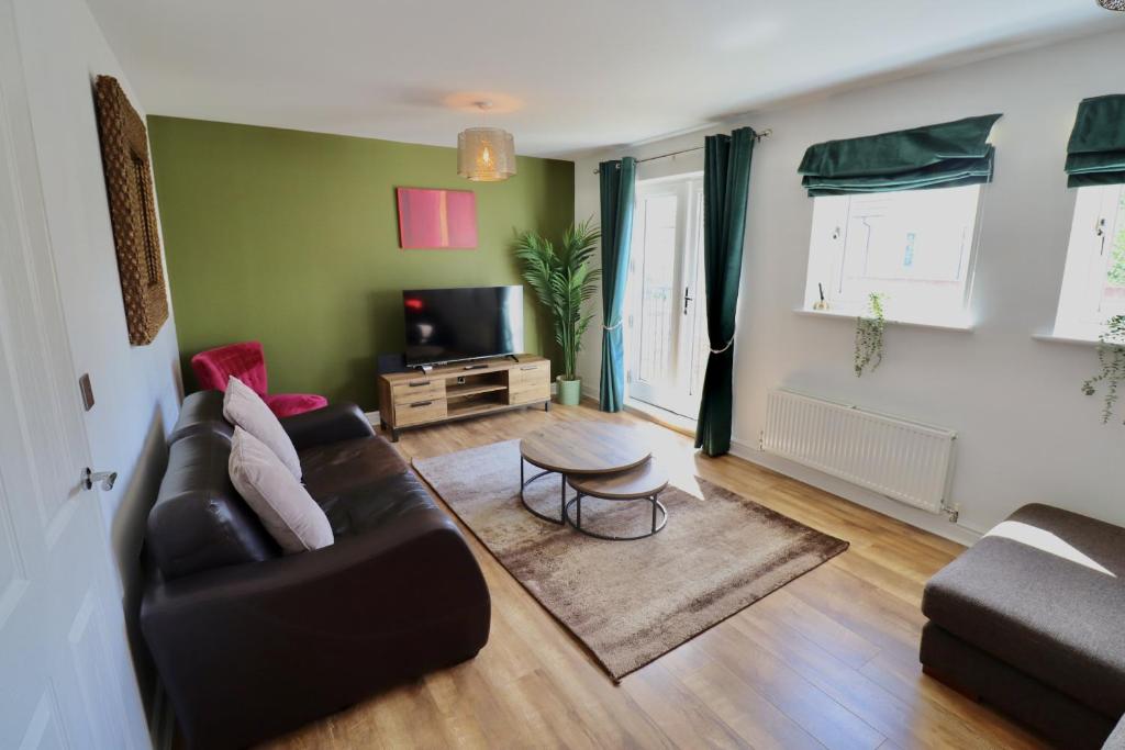 a living room with a couch and a table at Spacious 4-Bed Home in Bracknell in Bracknell